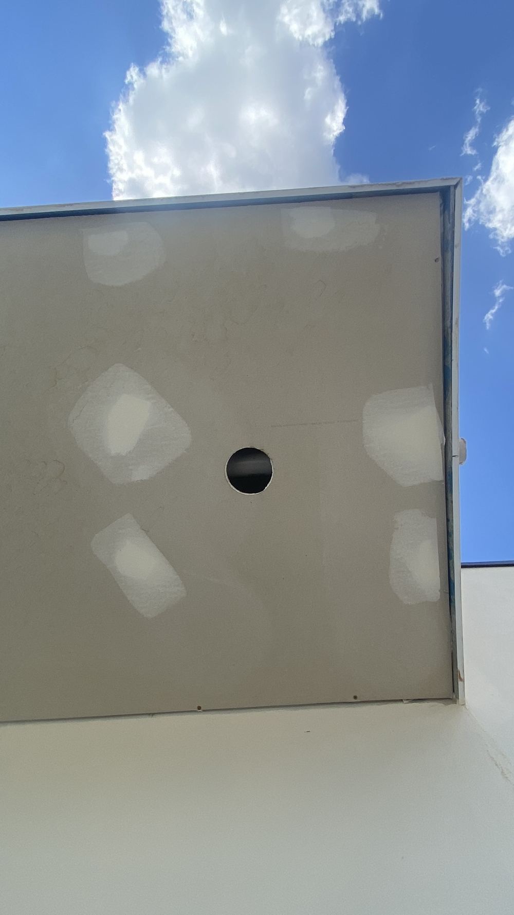 Balcony drain pipe smaller than the plumbing standard needs for heavy rain, found during a defect investigation in Tallawong