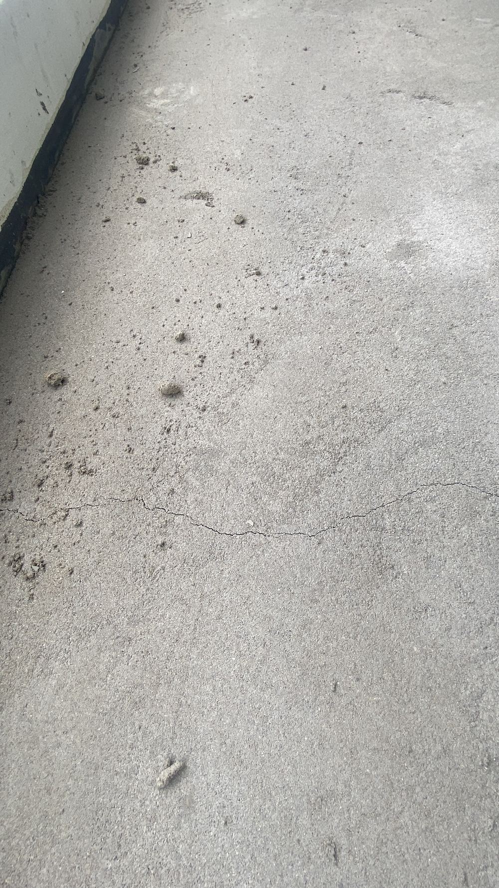 More screed cracking across the same balcony surface, Tallawong