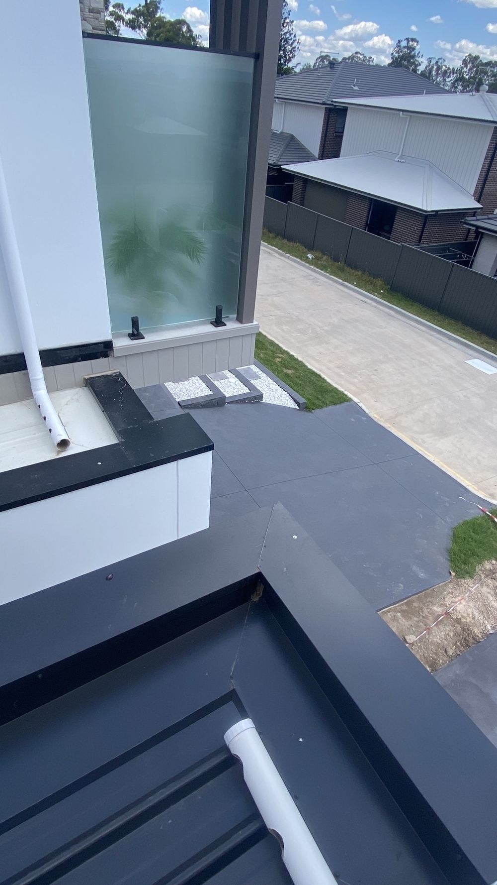 Parapet capping fasteners spaced wider than the 40mm the code allows, Tallawong