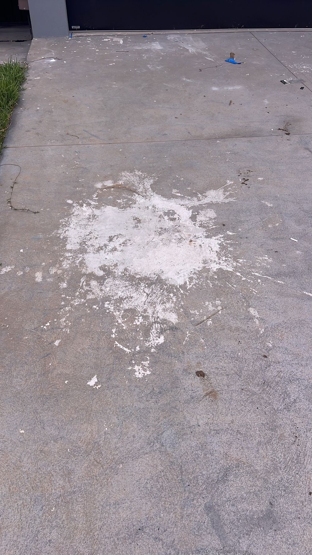 Coloured concrete driveway with patchy, mismatched shades between pours, Tallawong