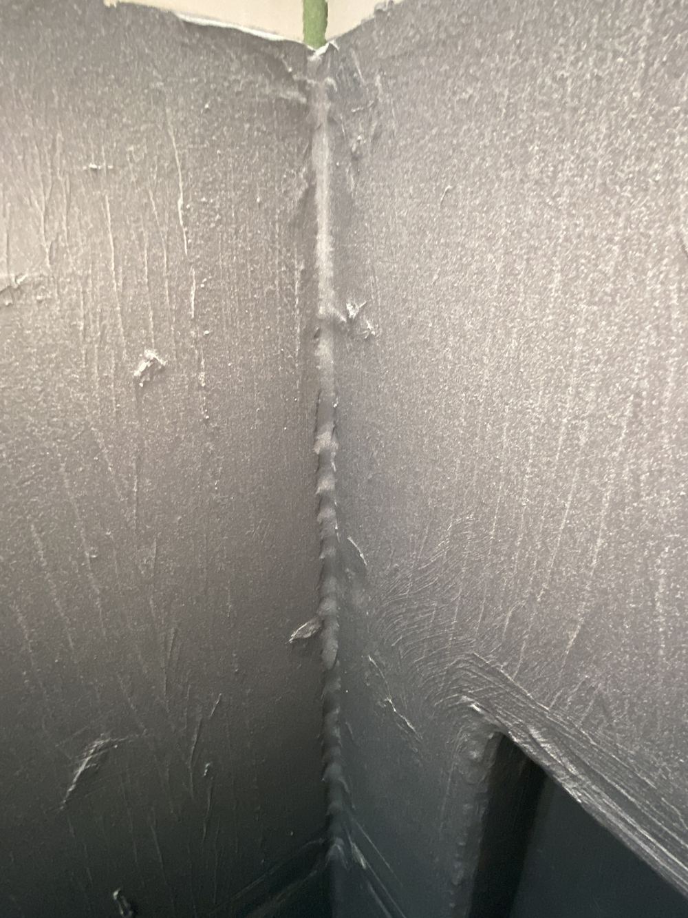 No bond breaker at a vertical shower corner under the membrane, found during a fixing stage inspection in Kellyville