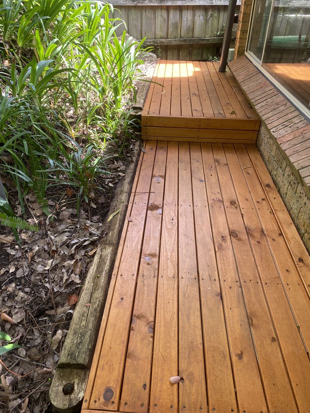 Timber decking sitting directly on soil, inviting decay and termites, found during a building and pest inspection in St Ives