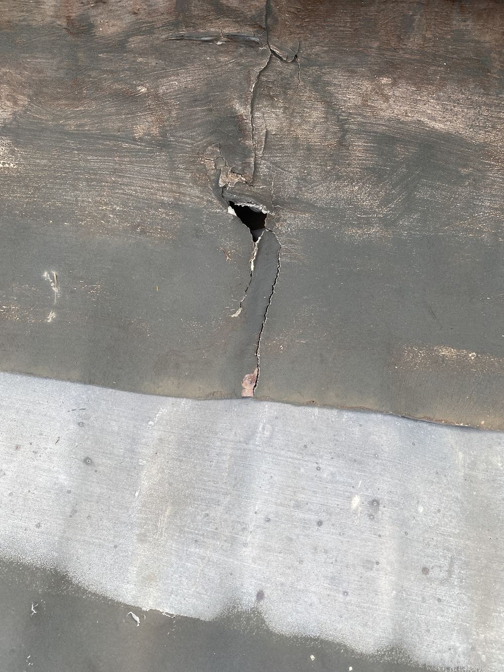 Roof flashing badly corroded, a likely path for leaks and mould, found during a pre-purchase inspection in St Ives