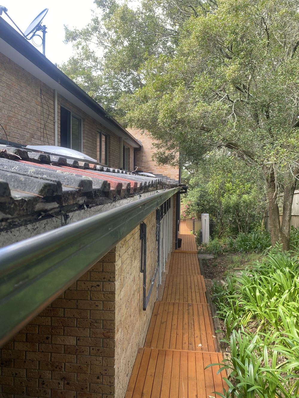 Wavy roof tiles over battens weakened by termite damage, found during a building and pest inspection in St Ives