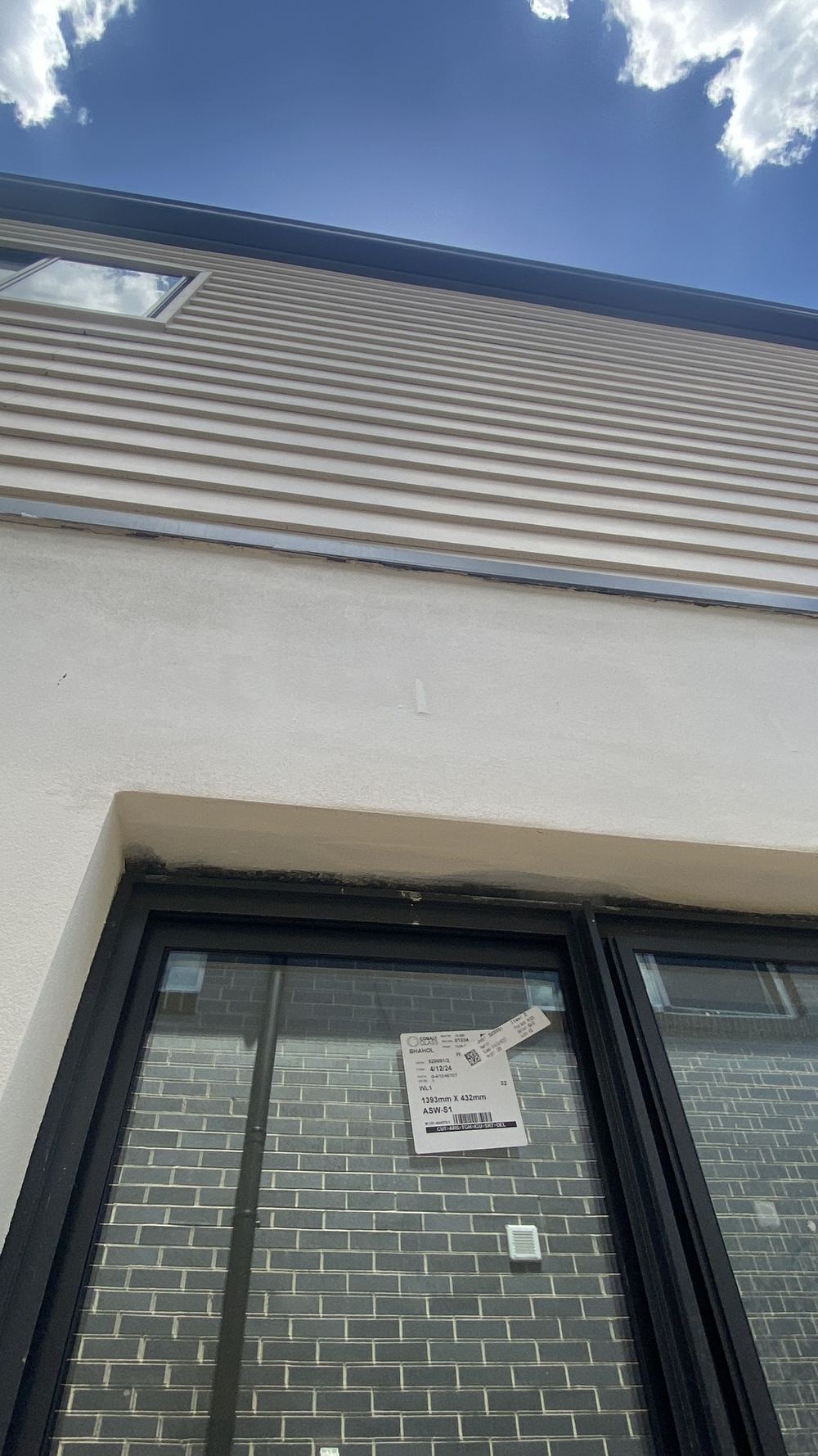 Weep holes choked with mortar and render, so the cavity cannot drain, Tallawong